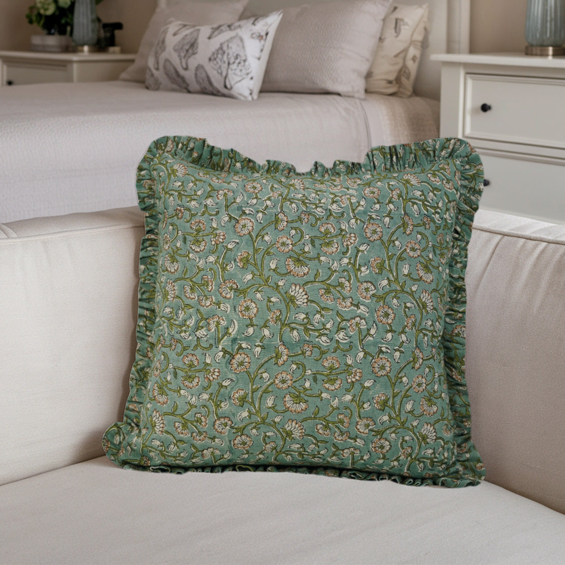 Beige sofa with floral frill linen pillow cover.