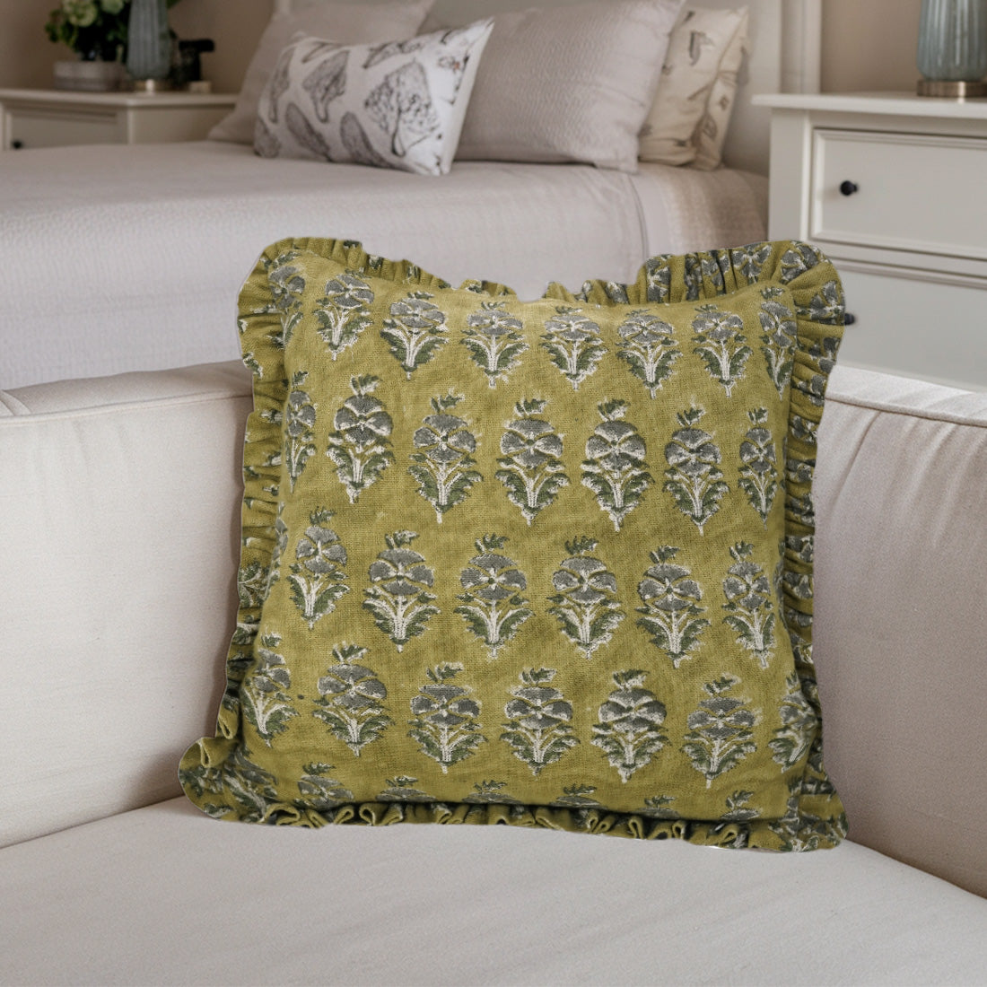 Beige sofa brightened with a charming green frill linen pillow cover featuring a delicate floral pattern.