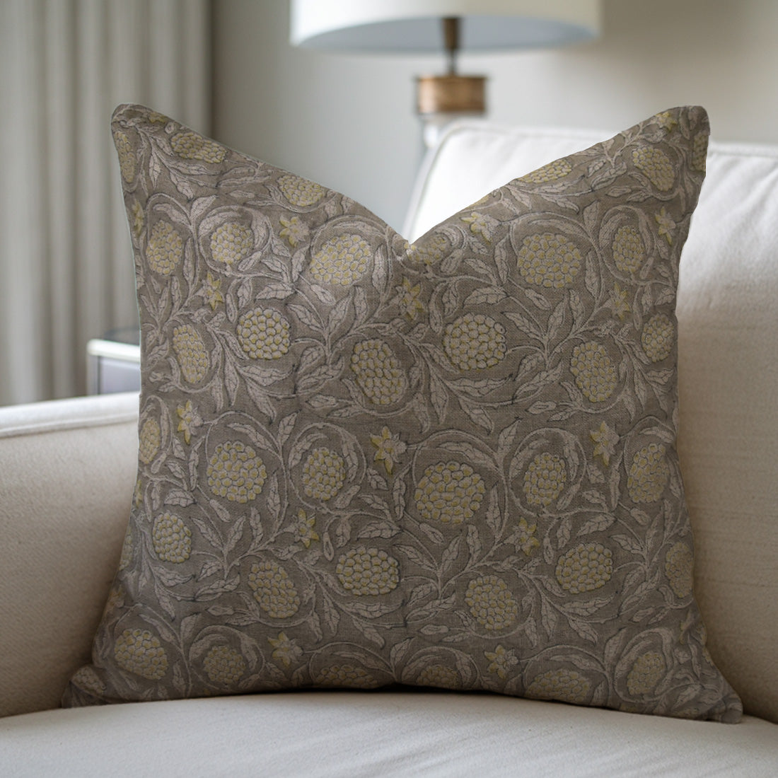 Decorative pillow with floral pattern on a beige sofa