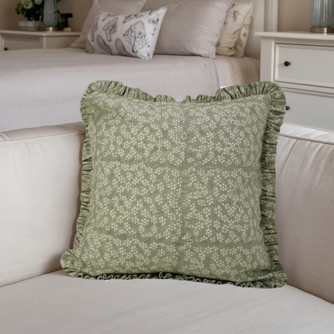 Beige sofa with vibrant green frill linen pillow covers for a cozy touch.