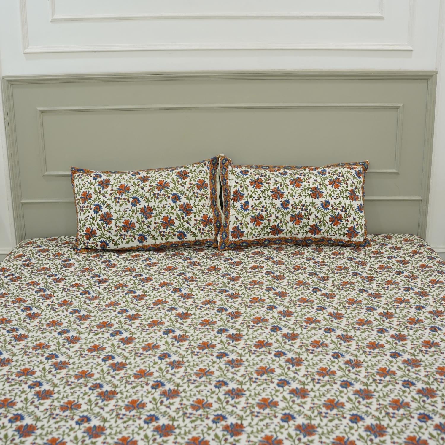 Let your bedroom bloom with handcrafted beauty. This hand block printed bedsheet on pure cotton, paired with pillow covers, captures floral artistry in soft tones. Each piece echoes heritage and the skill of artisans.
