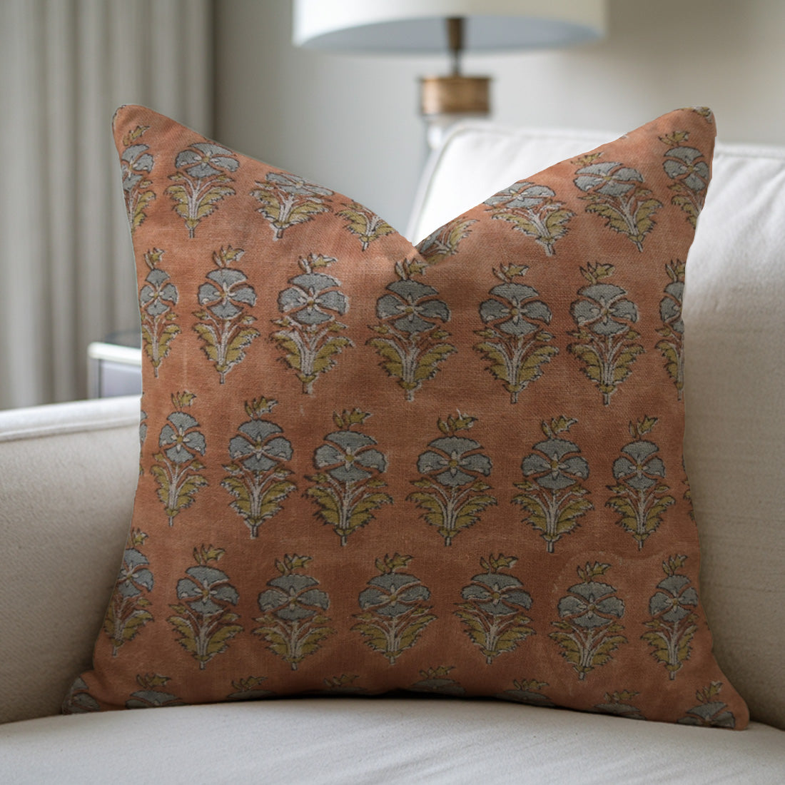 Decorative pillow with floral pattern on a beige sofa