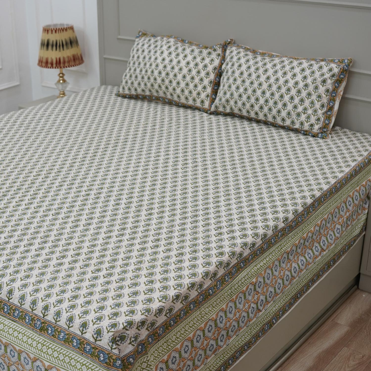 A beautifully handmade bedsheet featuring floral hand block prints. Made from breathable cotton and paired with pillow covers, it adds warmth and handmade soul to your bedding.
