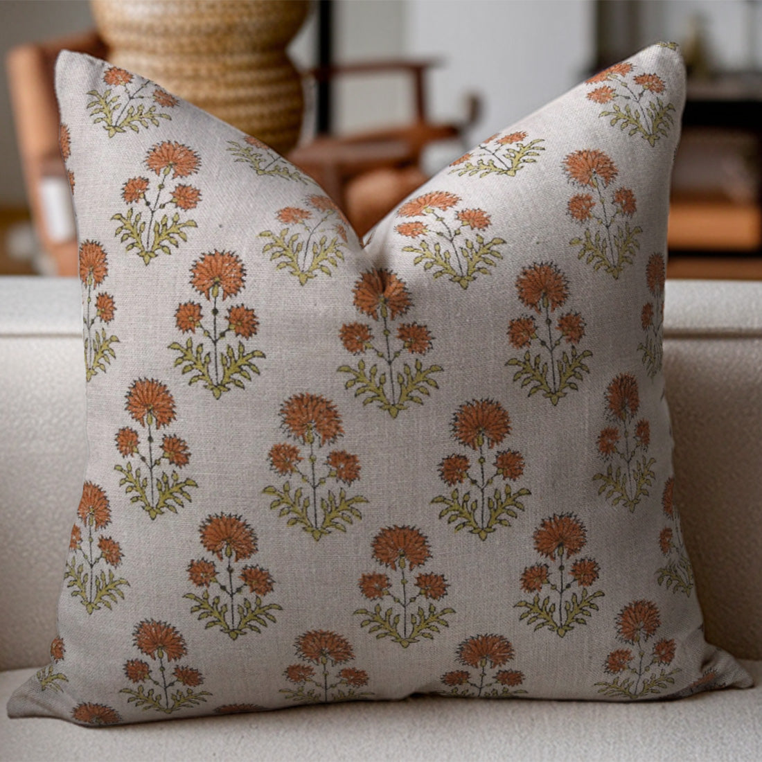 Rishi linen pillow with floral pattern on a beige sofa