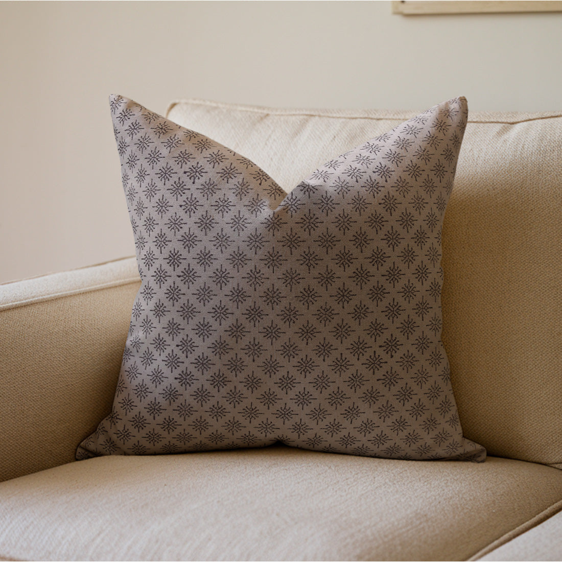 Patterned pillow on a beige sofa