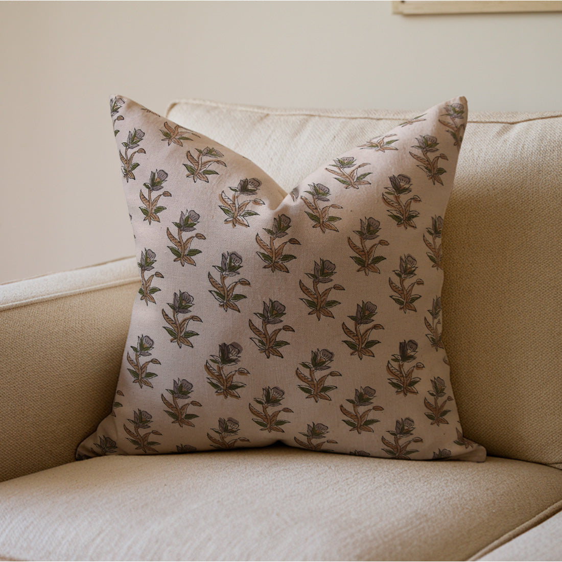 Block printed  pillow with floral pattern on a beige sofa