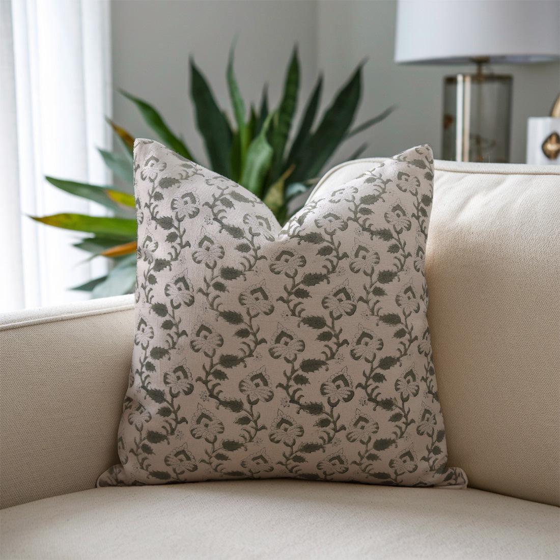 Decorative pillow with floral pattern on a beige sofa