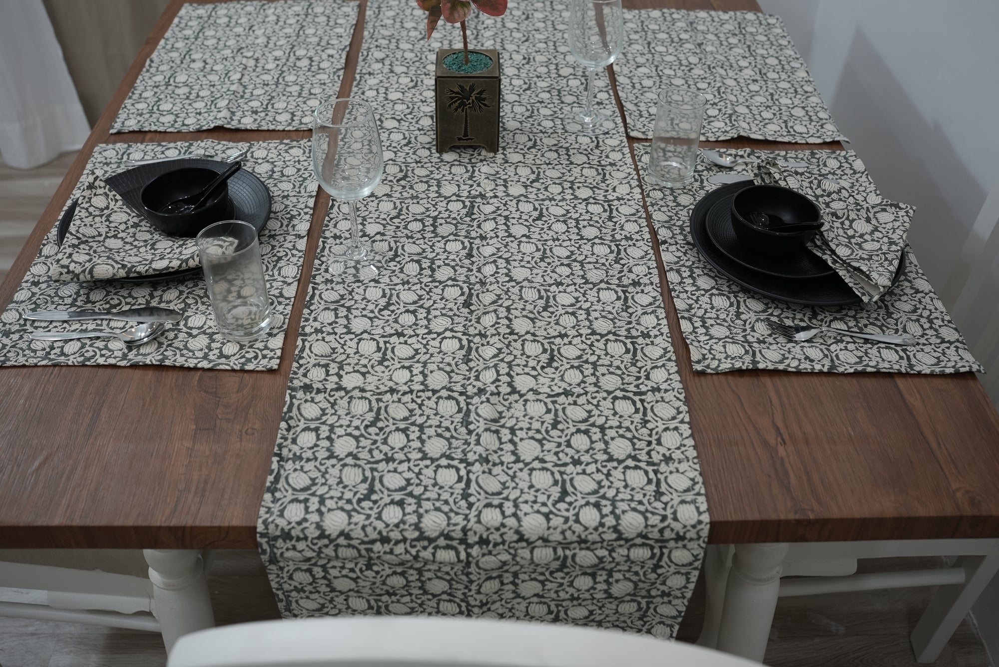Gray block print table cloth elegantly set on a wooden dining table