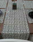 Gray block print table cloth elegantly set on a wooden dining table