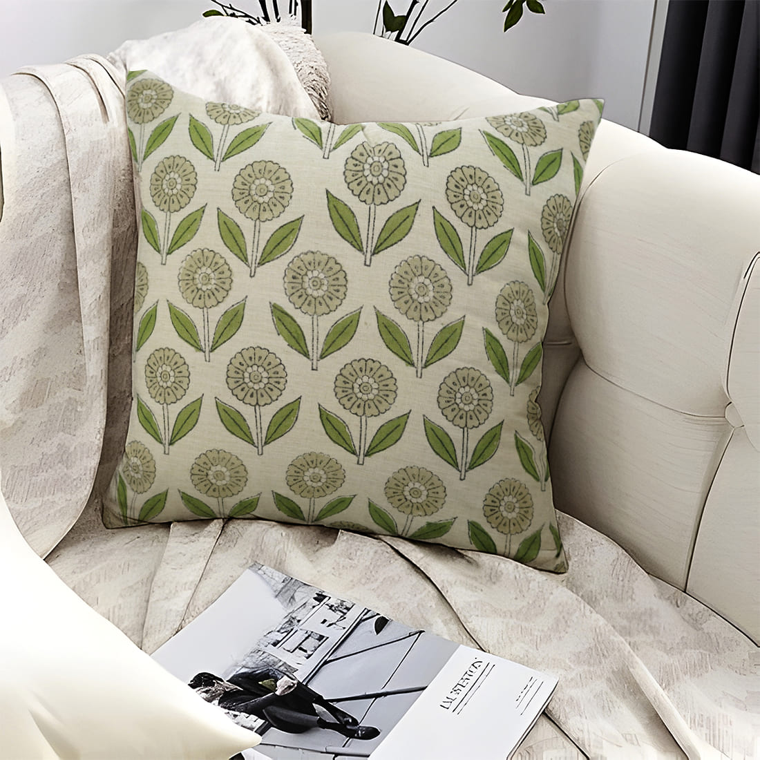 Decorative pillow with green floral handblock print placed on a beige sofa