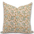 Decorative pillow with green and white floral pattern on a beige background