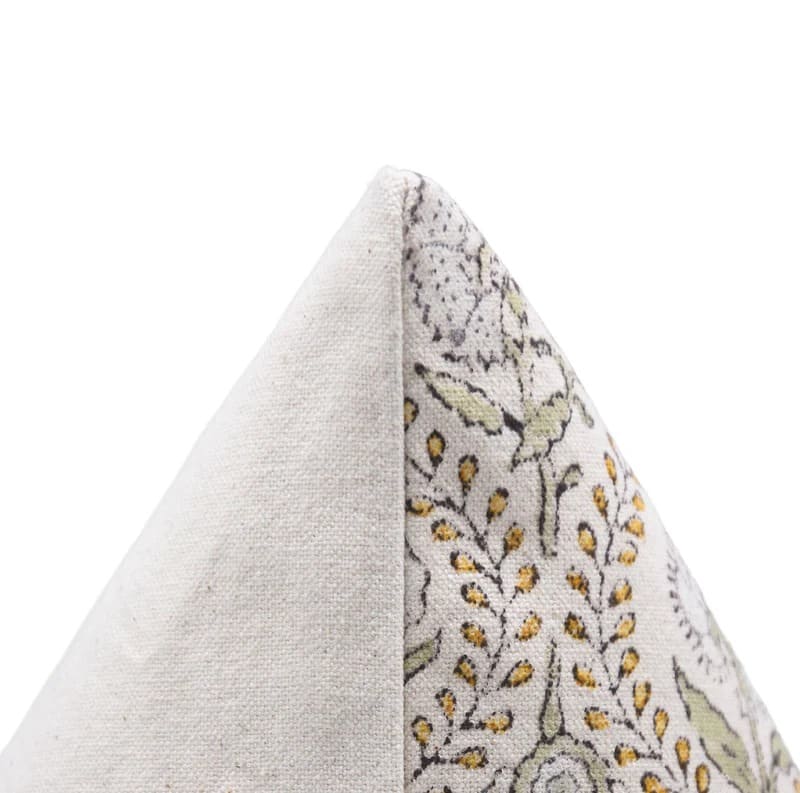 Close-up of a decorative pillow with floral pattern on a white background