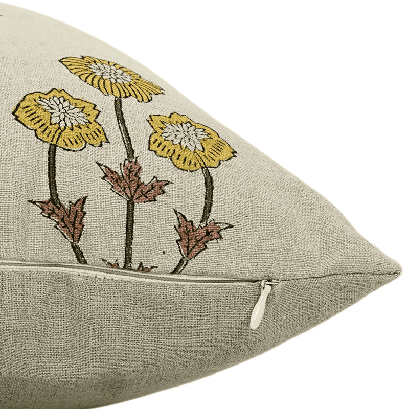 Decorative pillow with embroidered flowers on a beige background