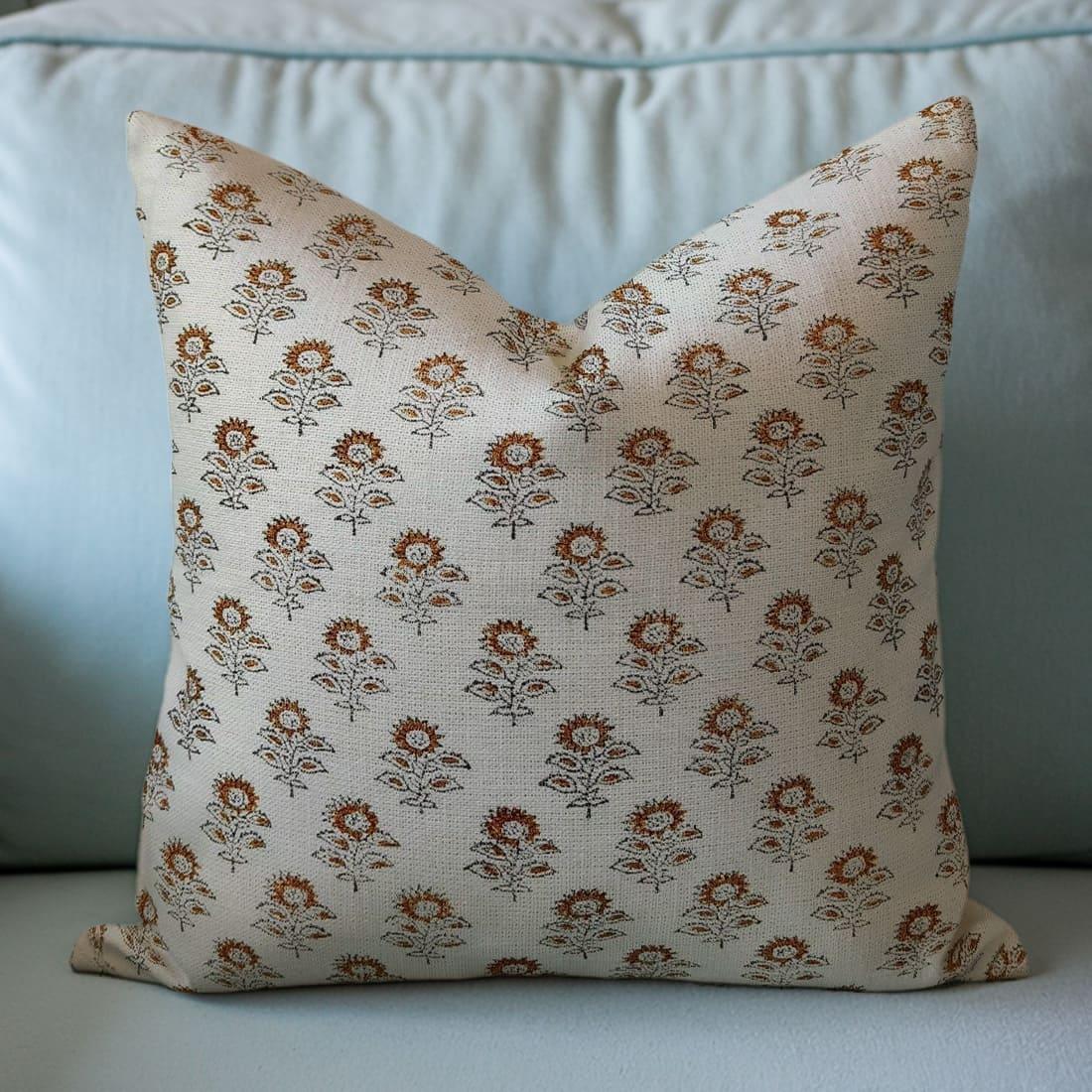 Decorative pillow with floral pattern on a light blue sofa