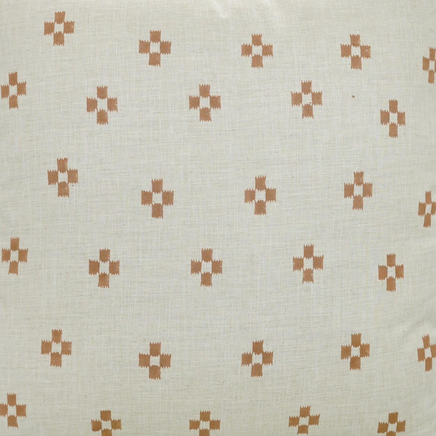 Patterned fabric with small geometric designs on a beige background