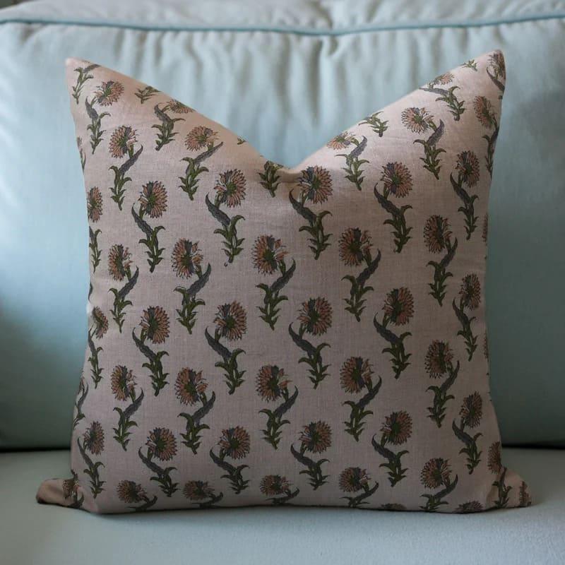 Decorative pillow with floral pattern on a light blue sofa