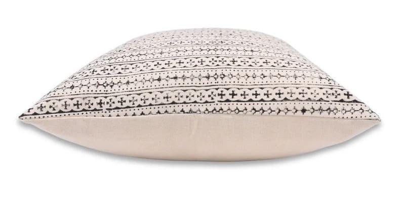 Decorative pillow with a geometric pattern on a beige background
