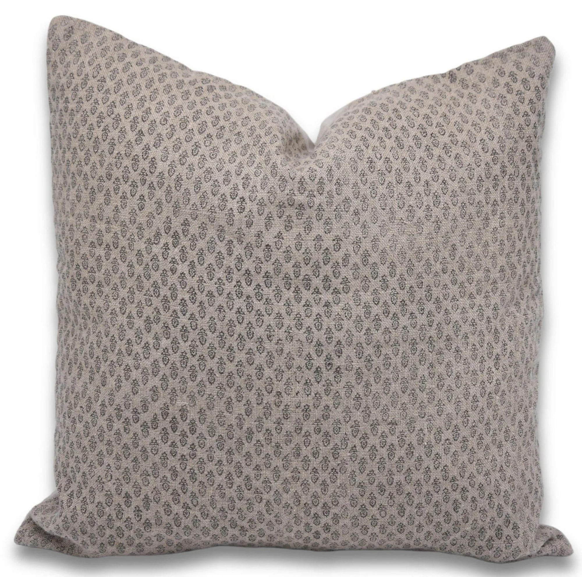 Patterned pillow on a beige linen cover
