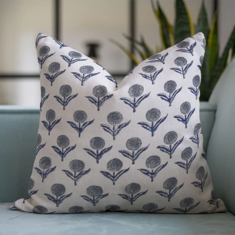 Decorative pillow with floral pattern on a light blue sofa