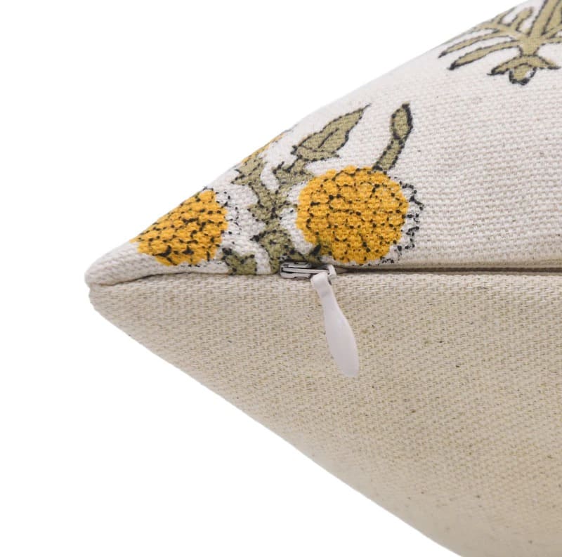 Beige pillow with floral embroidery on a white duck canvas fabric