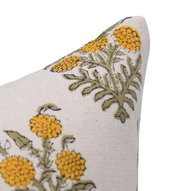 Floral embroidered pillow with yellow flowers and green leaves on a white duck canvas fabric