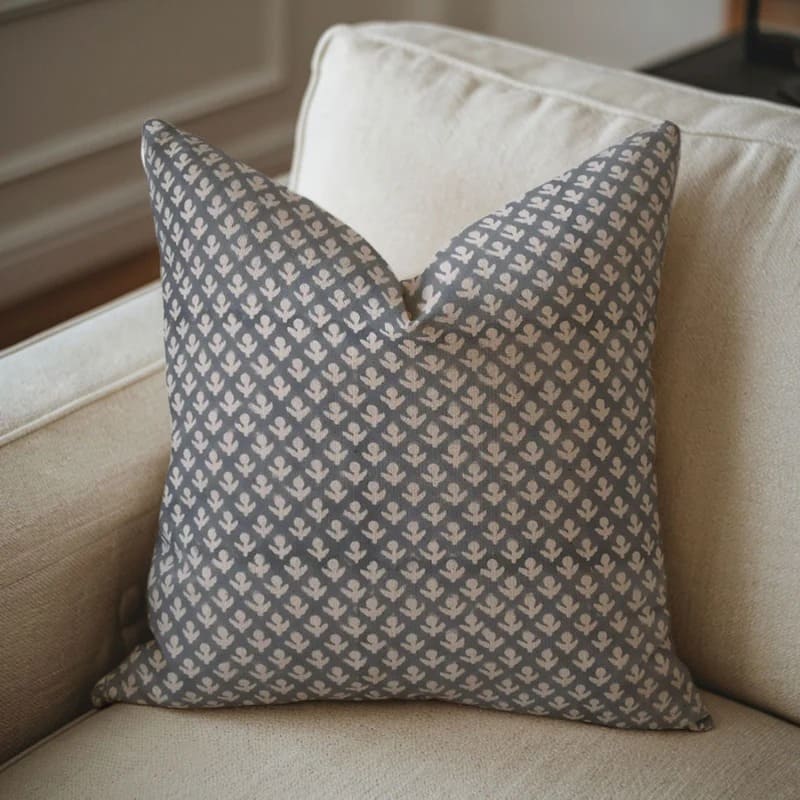Gray patterned pillow on a beige sofa