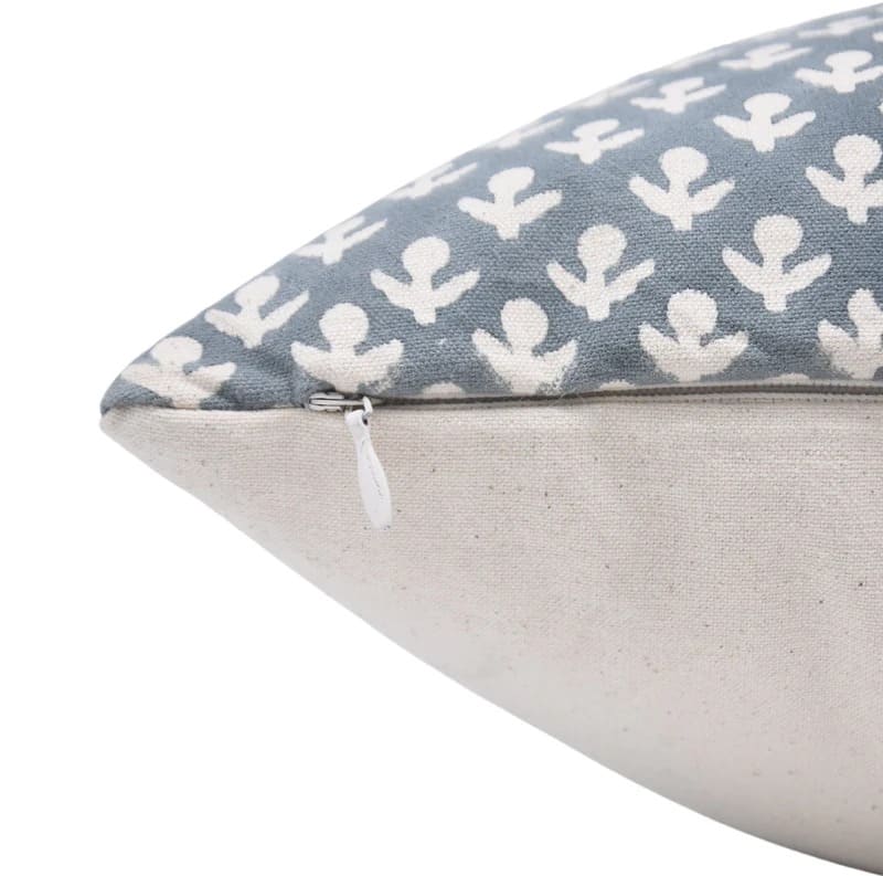 Boho pillow with white floral pattern on a blue and white canvas fabric 