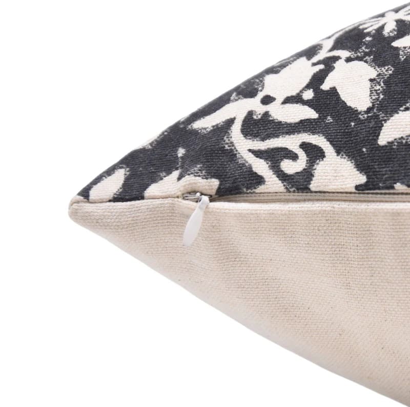 Decorative pillow with black and white floral pattern on a beige duck canvas fabric