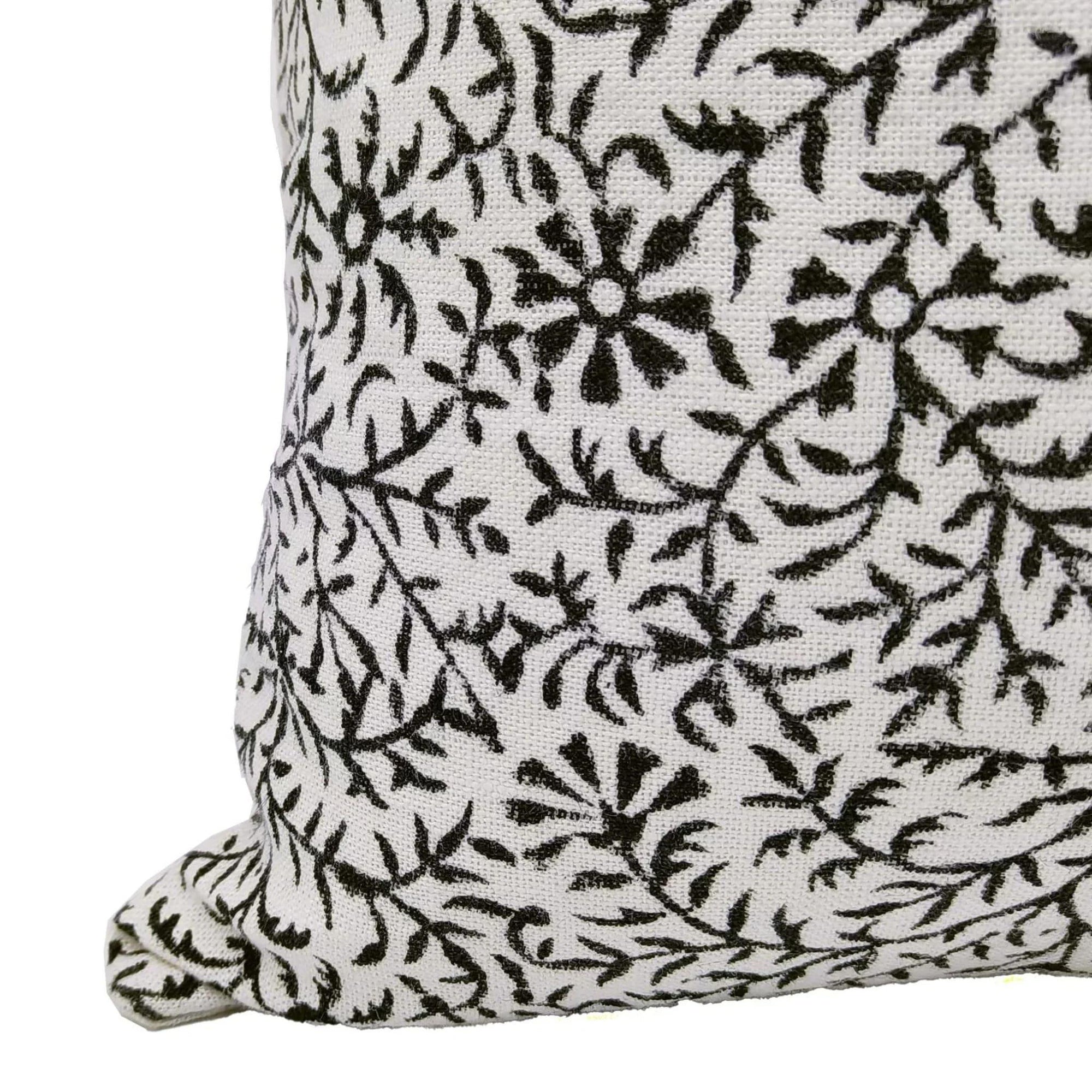 Black floral pattern on a white pillow