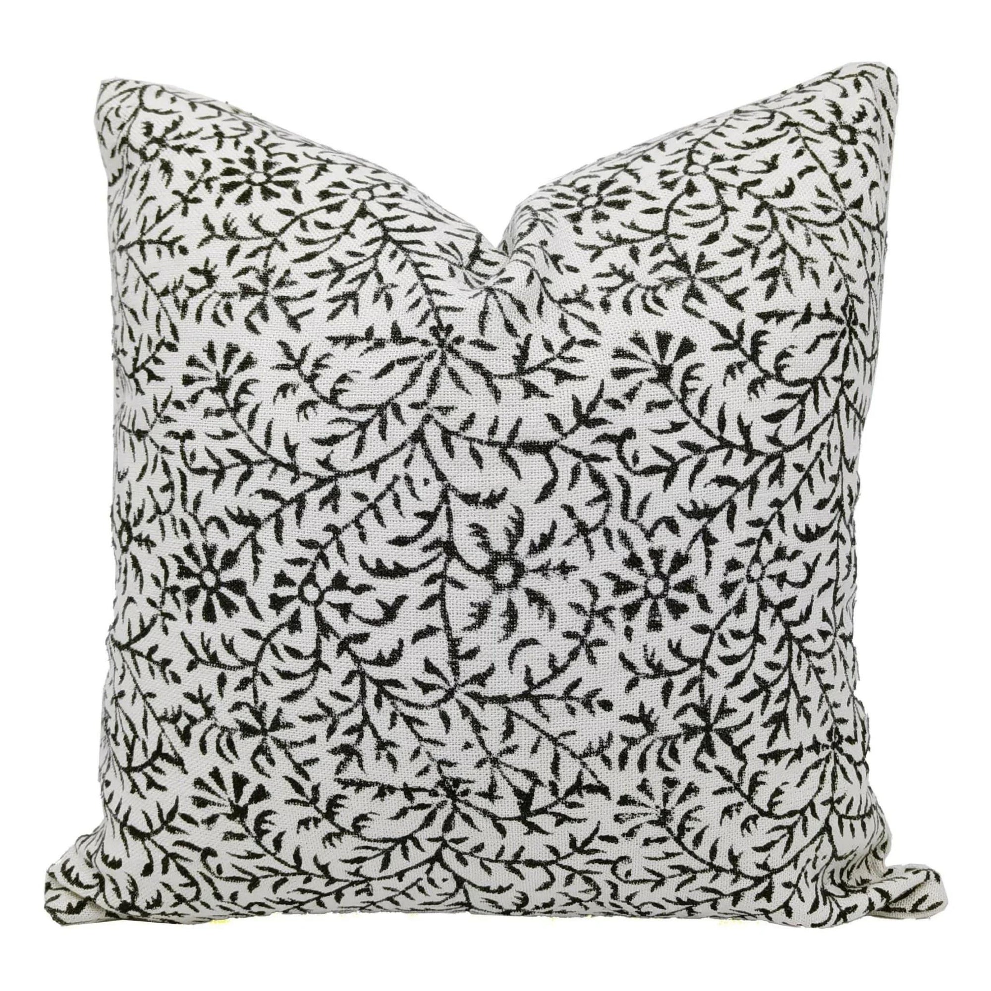 Decorative pillow with black floral pattern on a white background