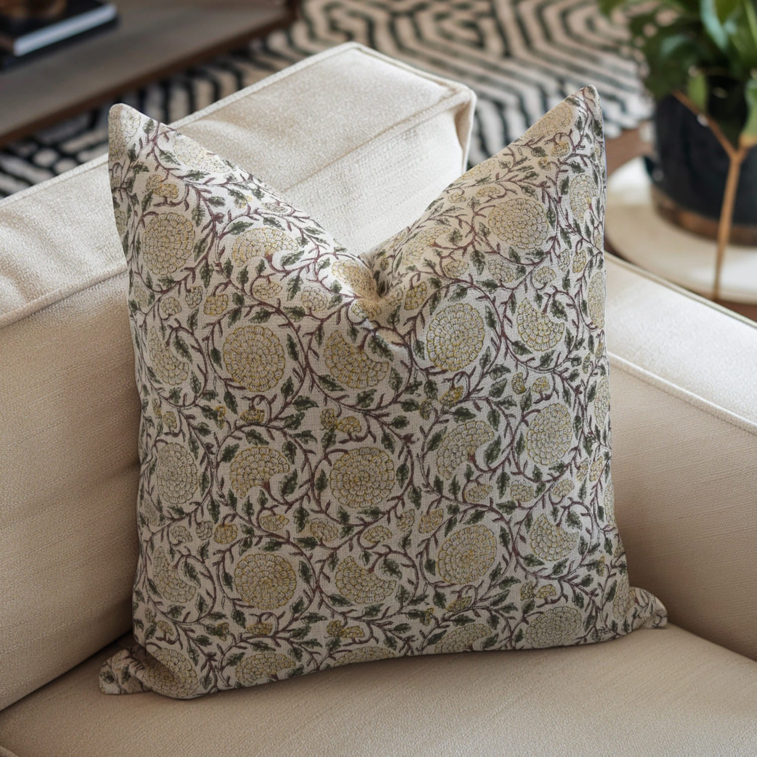 Decorative pillow with floral pattern on a beige sofa