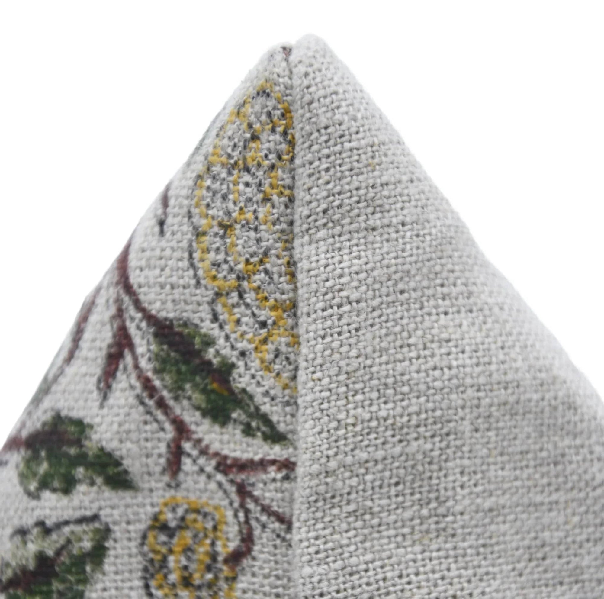 Textured fabric triangle with floral pattern on a white background
