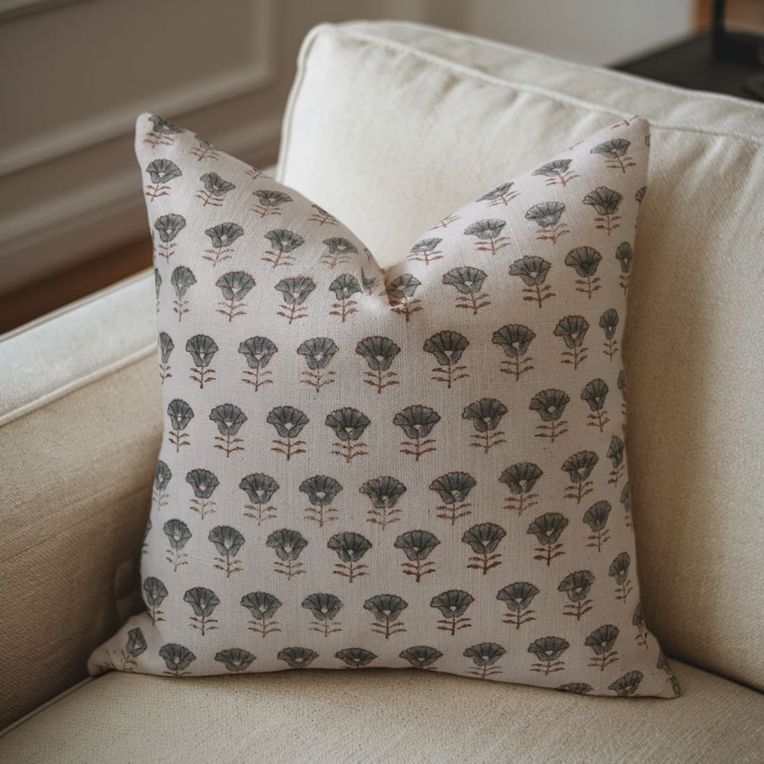 Decorative pillow with floral pattern on a beige sofa