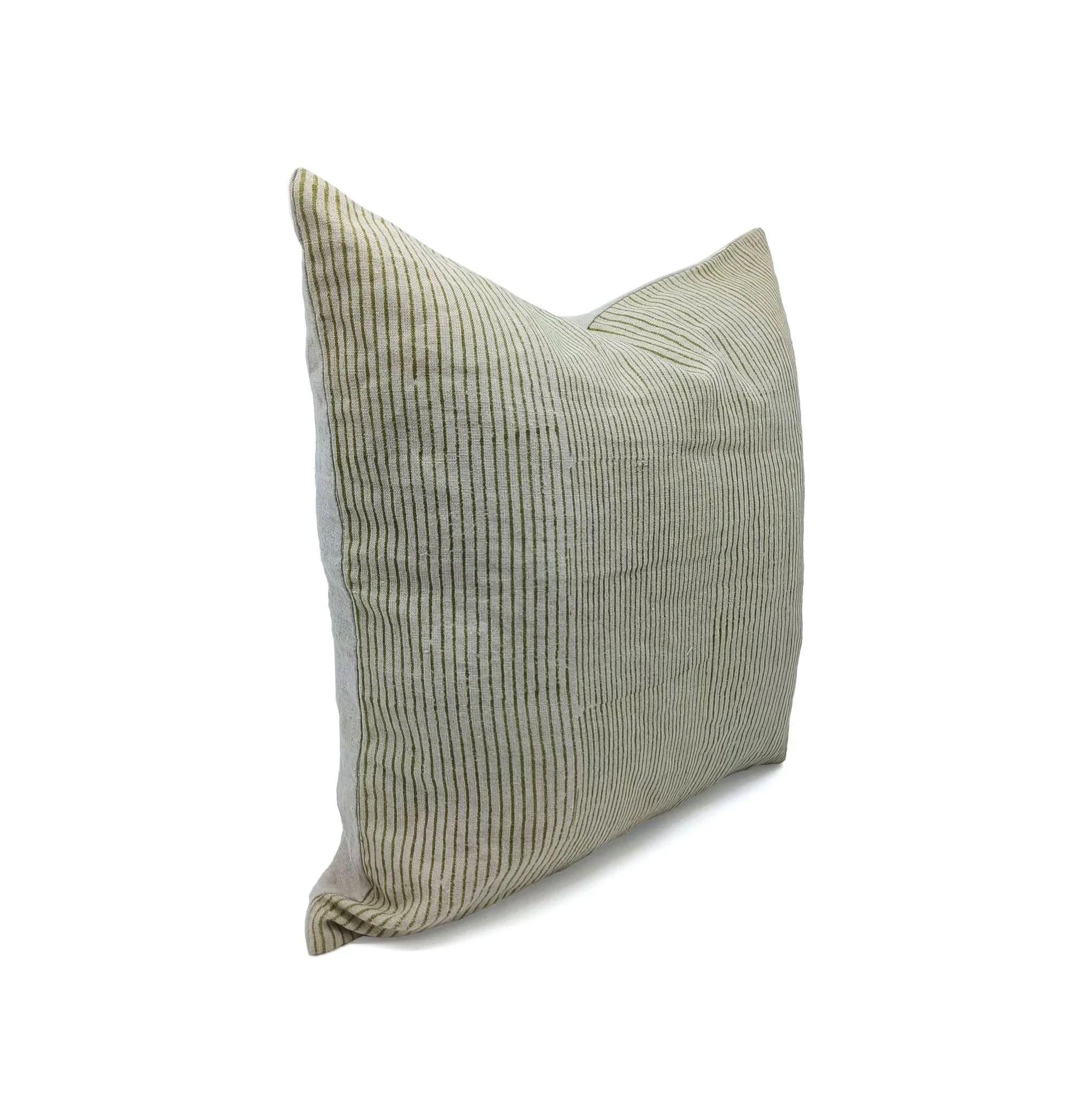 Textured green pillow on a white background
