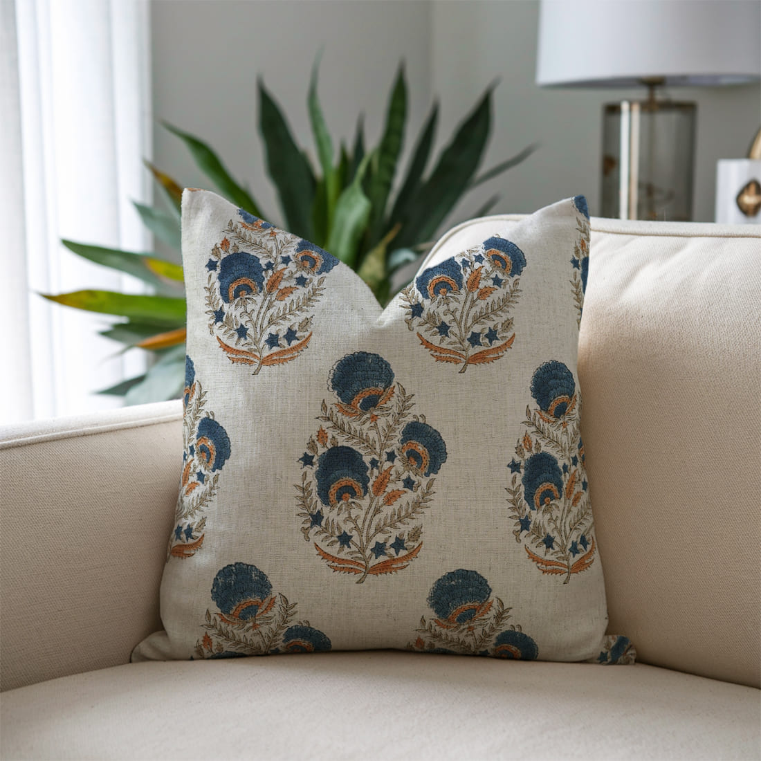 Decorative pillow with floral pattern on a beige sofa