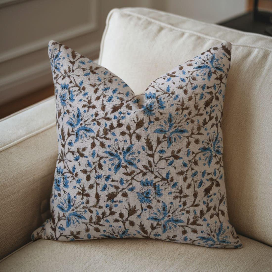 Blue and brown Floral patterned pillow on a beige sofa