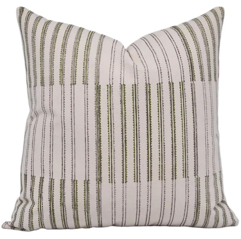 Striped pillow with green and brown lines on a white background