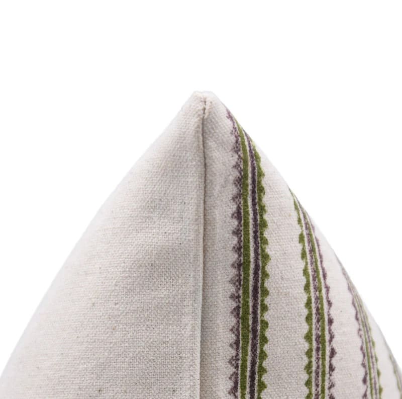 Textured fabric pillow with green and purple pattern if stripe