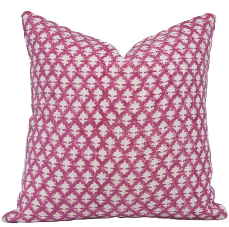 Pink and white patterned pillow on a white background