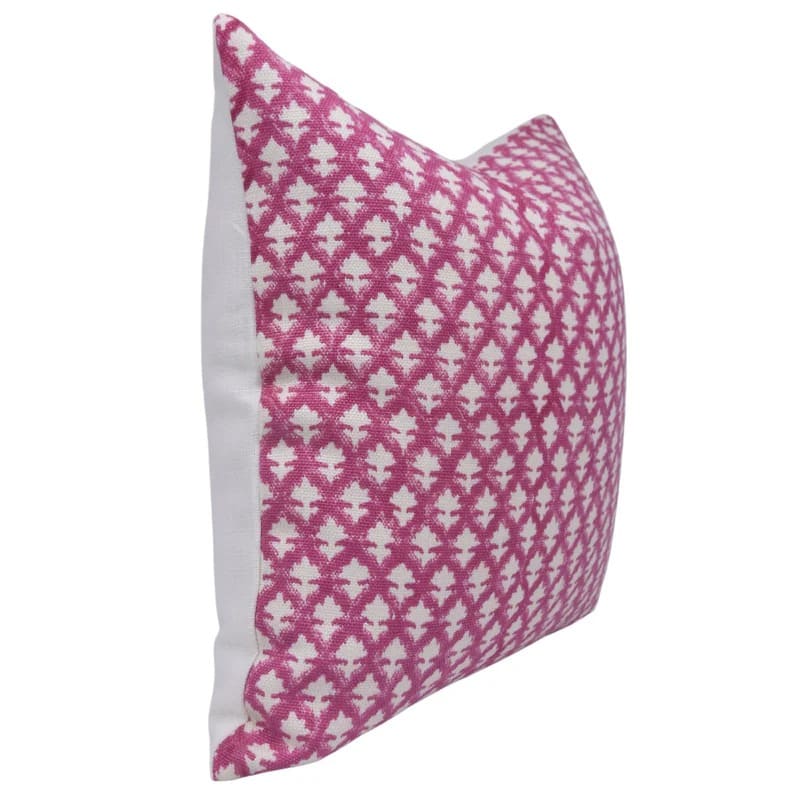 Decorative pillow with pink and white geometric pattern on a off white linen fabric