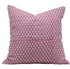 Pink pillow with white geometric pattern on a white background

