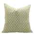 Green pillow with white floral pattern on a white background