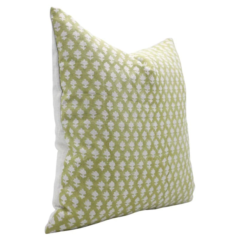 Green pillow with white floral pattern 
