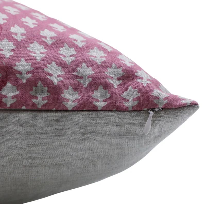 Pillow with pink and white patterned top half and gray bottom half on a white background