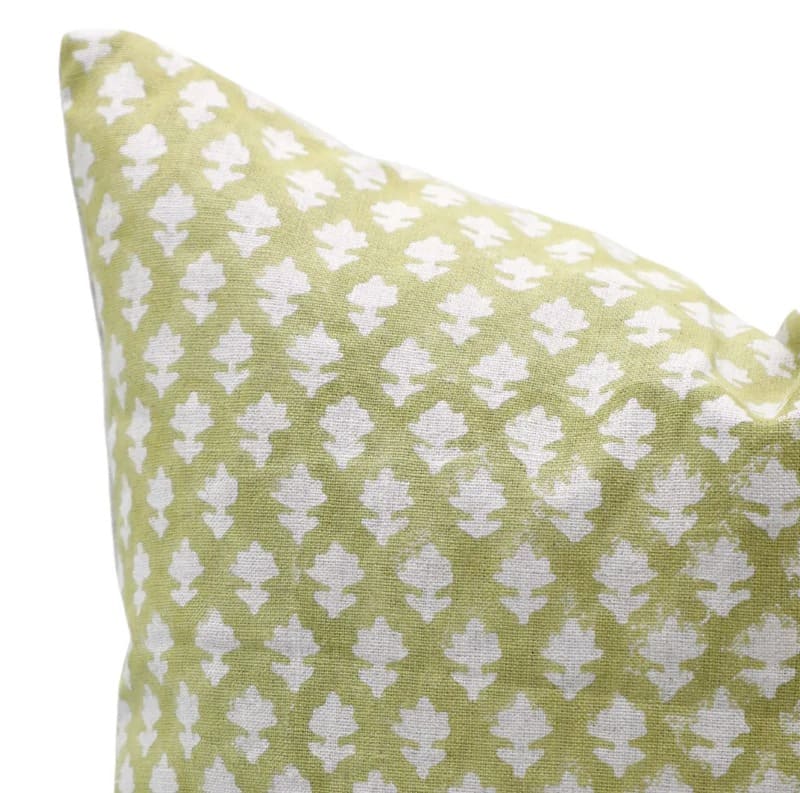 Green pillow with white geometric pattern 