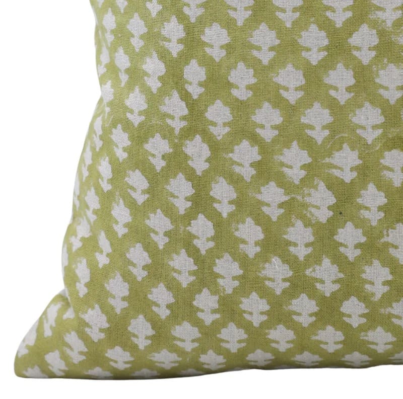 Green pillow with white floral pattern 