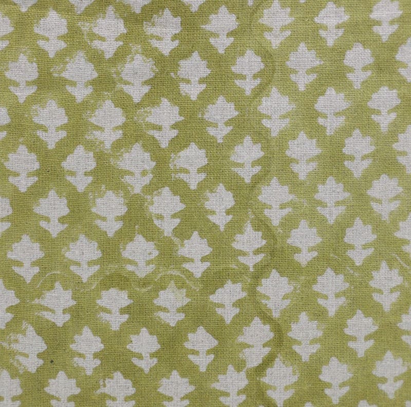 Patterned fabric with white leaf-like shapes on a green background