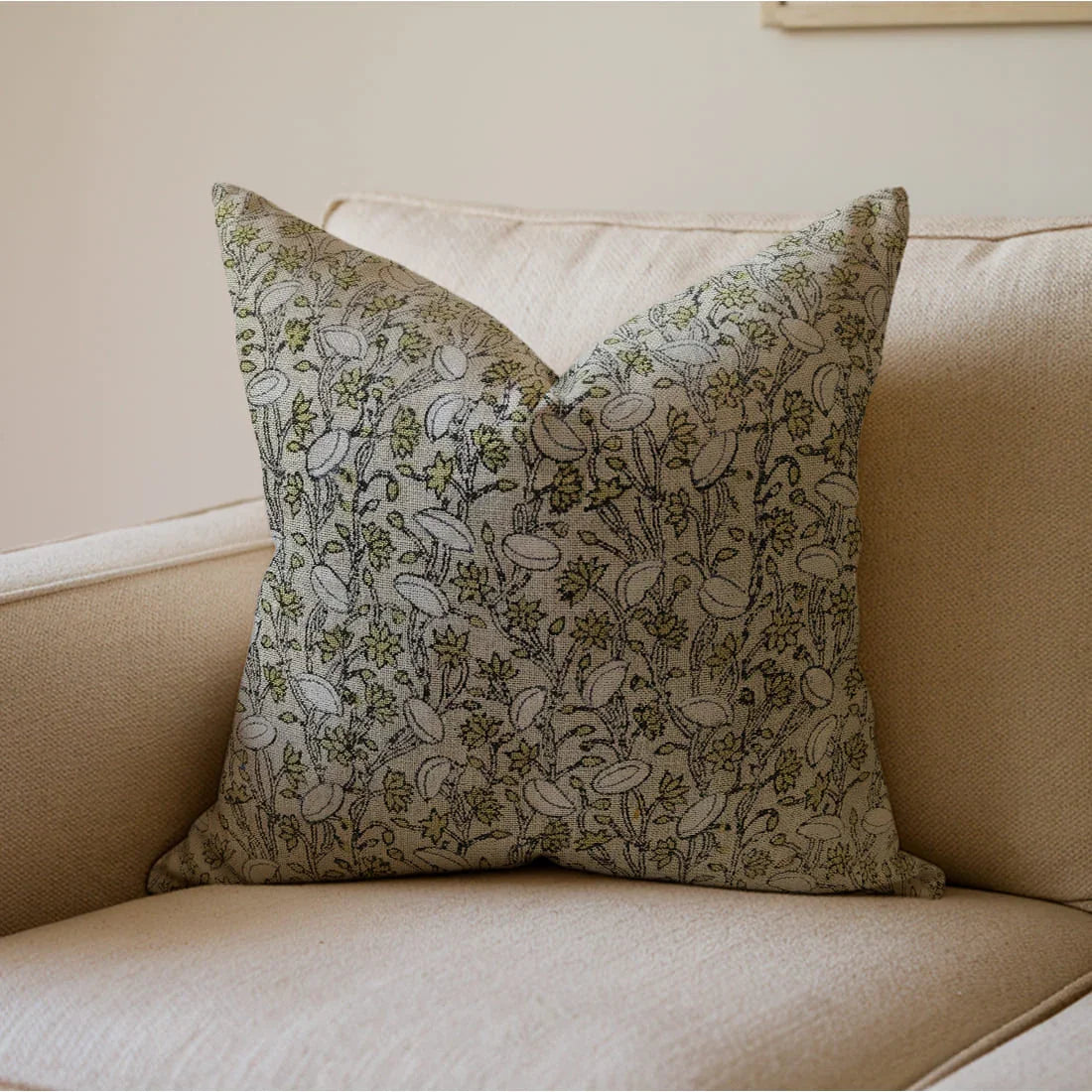 Decorative pillow with floral pattern on a beige sofa