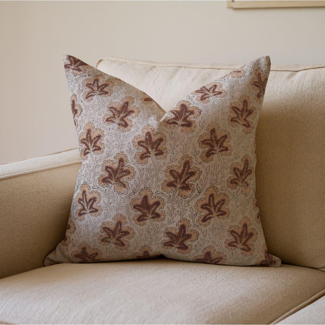 Decorative pillow with floral pattern on a beige sofa