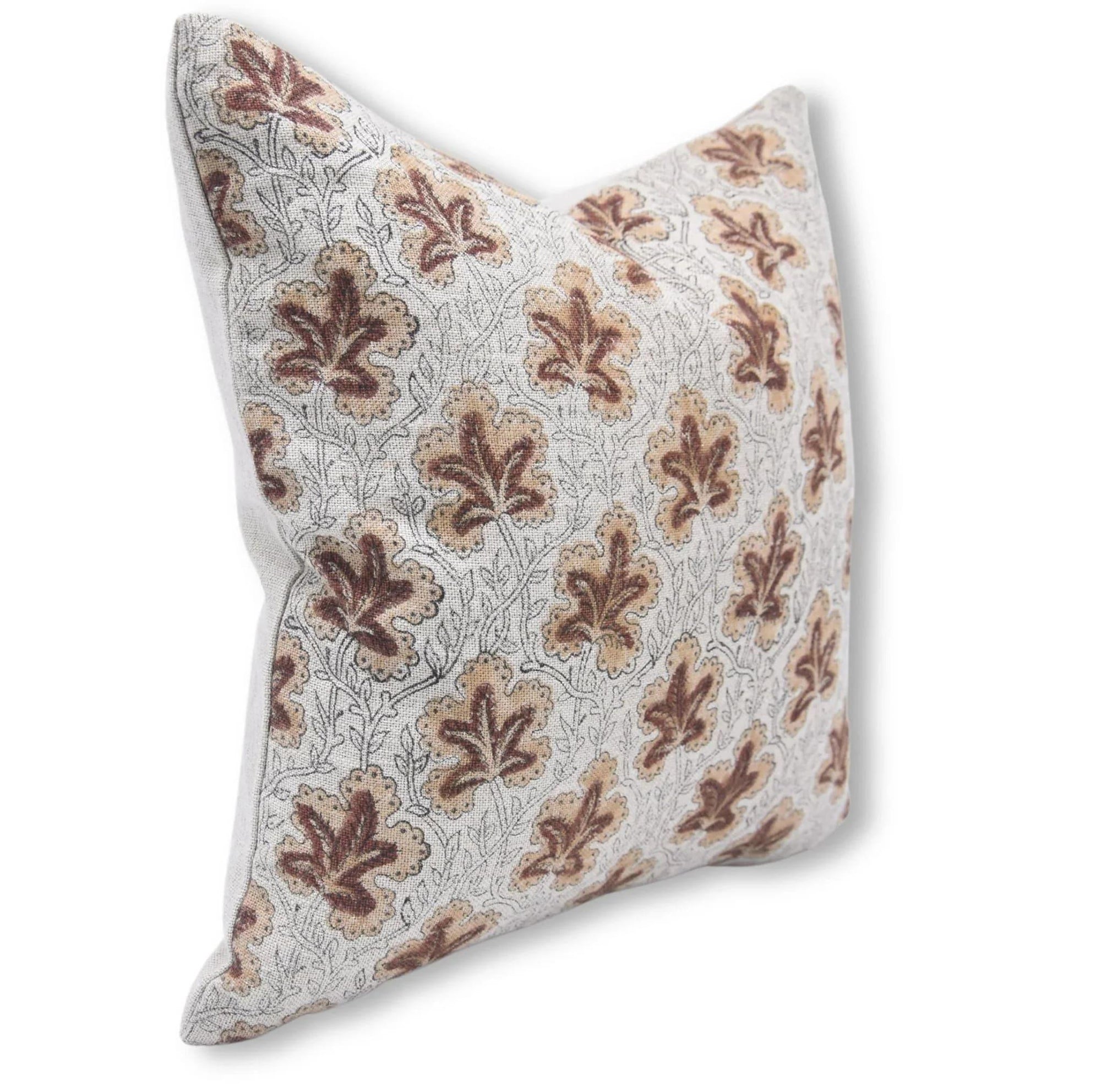 Decorative pillow with brown leaf pattern on a white background